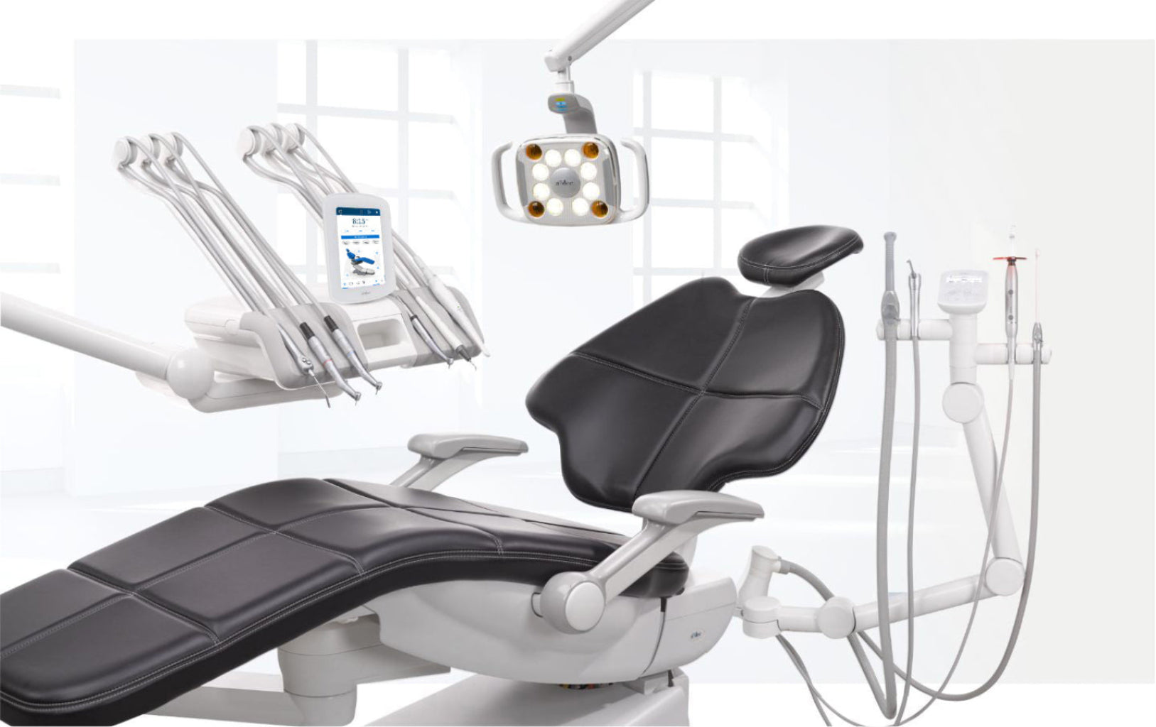 Dental chair with various dental tools and equipment on a white background